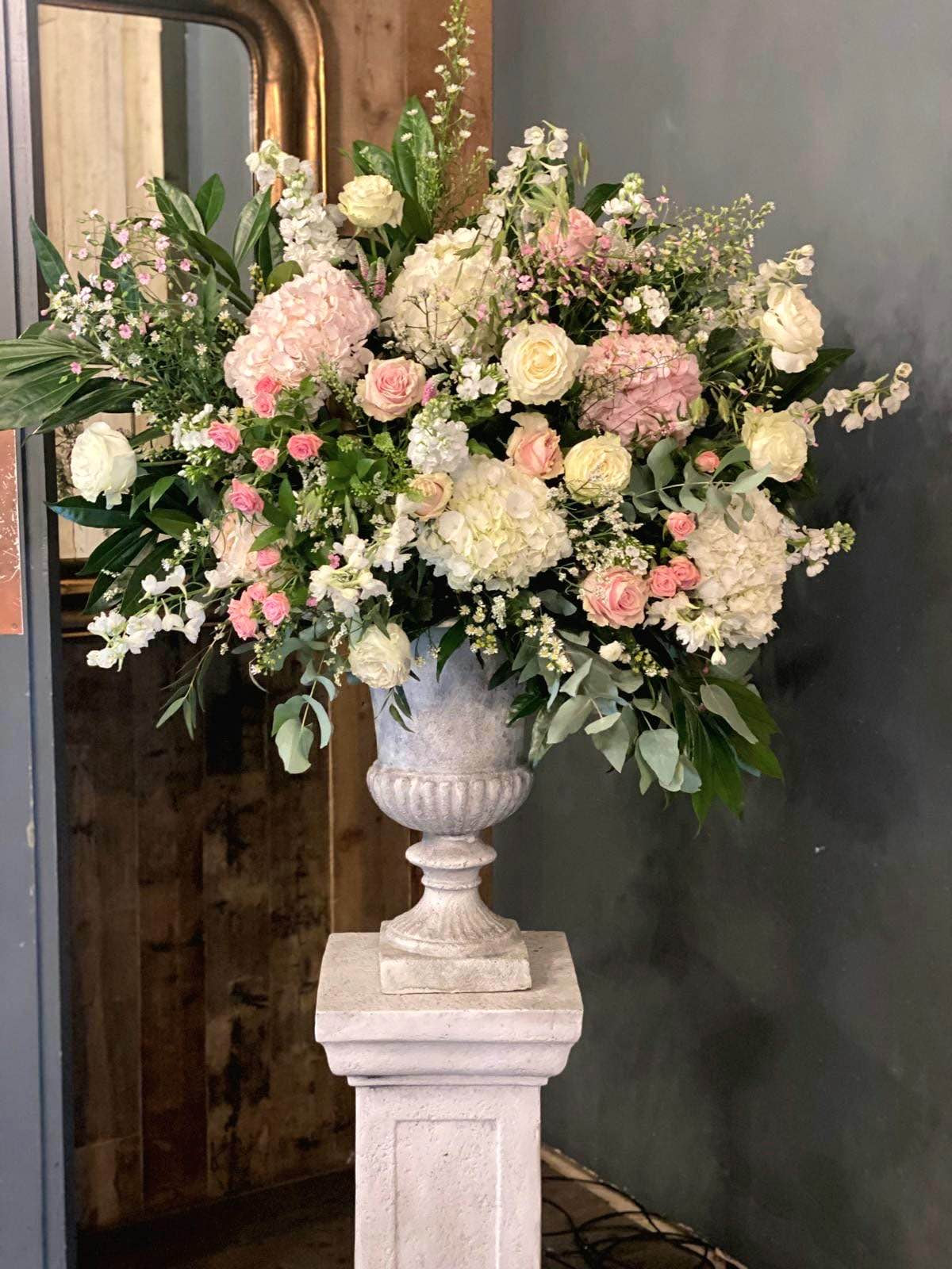 Ceremony flowers arranged either side of the aisle